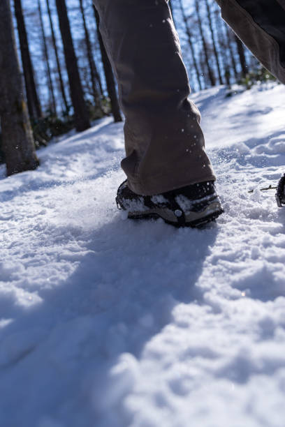 istock Crampons on feet climbing a snowy mountain 2198988574