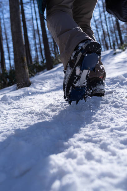 istock Crampons on feet climbing a snowy mountain 2198988609