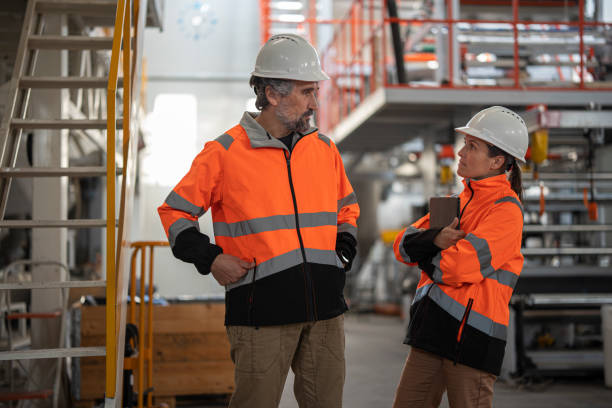 istock Two Engineers Discussing In Modern Industrial Factory 2198990152