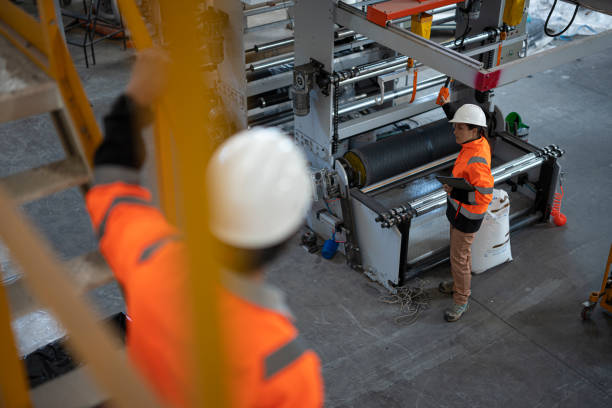 istock Two Engineers Discussing In Modern Industrial Factory 2198990158