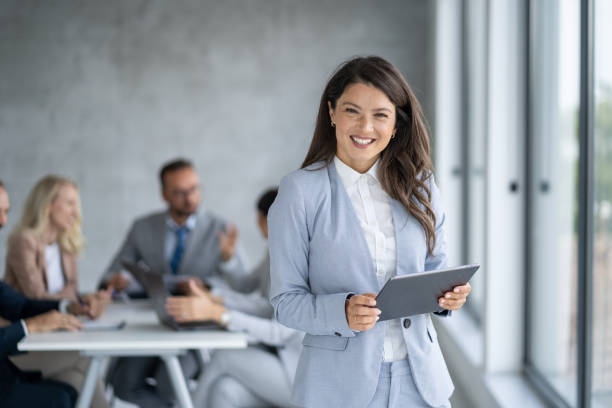 istock Professional businesswoman with tablet in modern office 2198990433