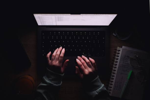 Close-up photo of a modern laptop keyboard captured in dramatic natural light and shadow. The image highlights clean lines and minimalist design, creating an abstract tech composition ideal for themes like remote work, digital tools, modern business environments, cybersecurity, and creative tech backdrops.