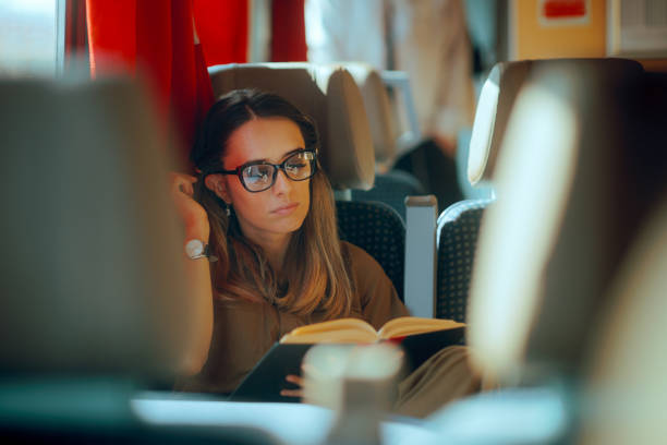 istock Commuting Woman Reading Peaceful in the Train while Travel 2198992117