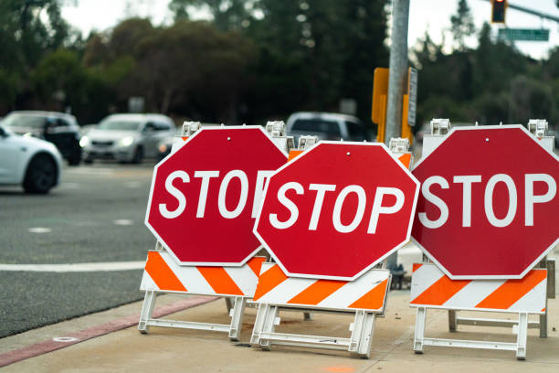istock Angled Row Of Three Stop Signs Arranged Across Sidewalk 2198993953