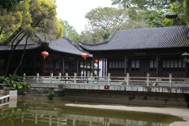 istock A bridge over a pond with a row of houses on either side 2198998709