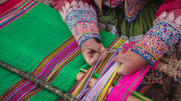 istock Peruvian woman weaving near Colca Canyon, Peru 2199001586