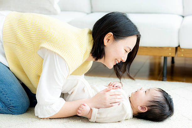 istock mom playing with baby 2199003882