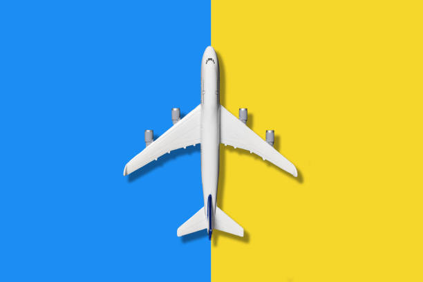 istock Model airplane on blue and yellow color background. 2199004847