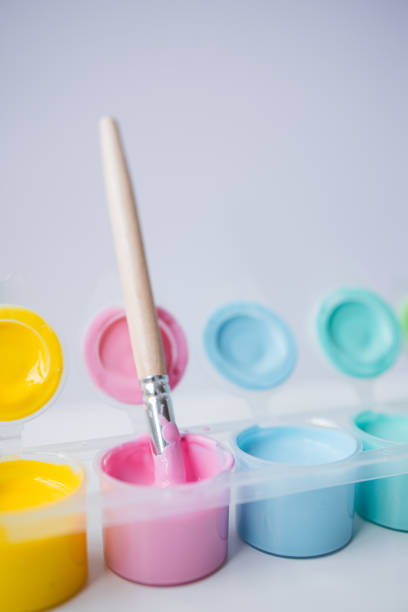 Colorful acrylic paints and brush set for creative projects.