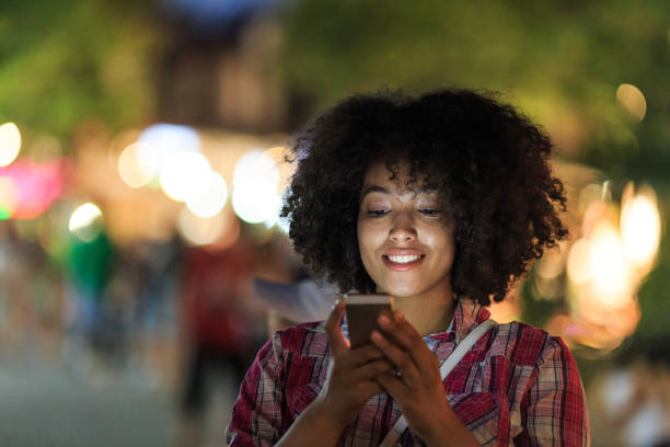 istock Smiling woman enjoying her smartphone 2199005493