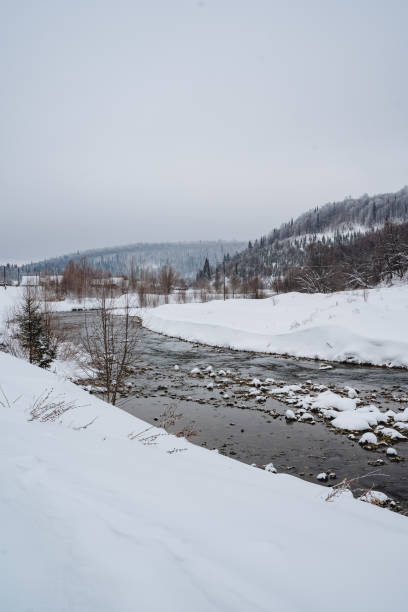 istock A beautiful river flows gracefully through a serene snowy landscape, with majestic mountains rising in the background, creating a picturesque winter scene that captivates the eye 2199007499