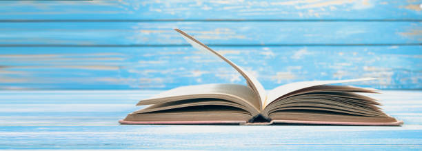 istock open book on blue wooden background 2199007831