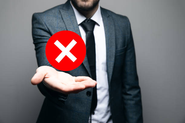 istock man holding a rejection icon in his hand 2199007877