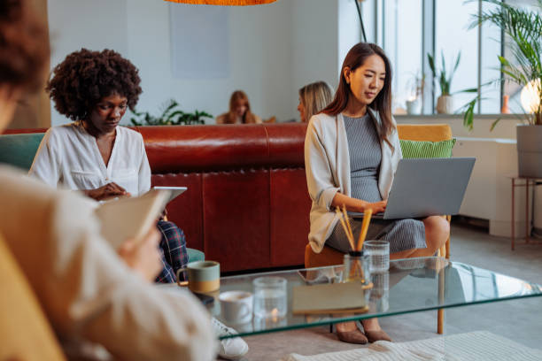 istock Businesswomen sitting and working in lobby 2199008565