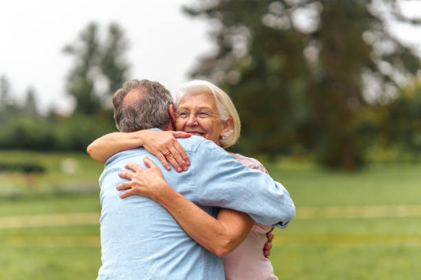 istock Senior Couple Embracing in Park 2199008694