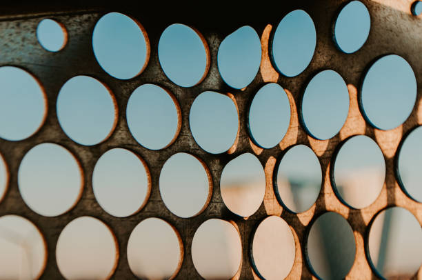 Punched circular holes in building facade detail in Copenhagen, Denmark