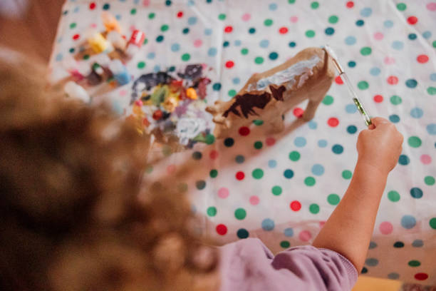 toddler with brown curly hair enjoying creative play in Amsterdam, North Holland, Netherlands