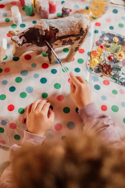 istock toddler with brown curly hair enjoying creative play 2199014408
