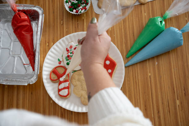 istock Decorating Christmas cookies with festive icing and holiday sprinkles 2199014904