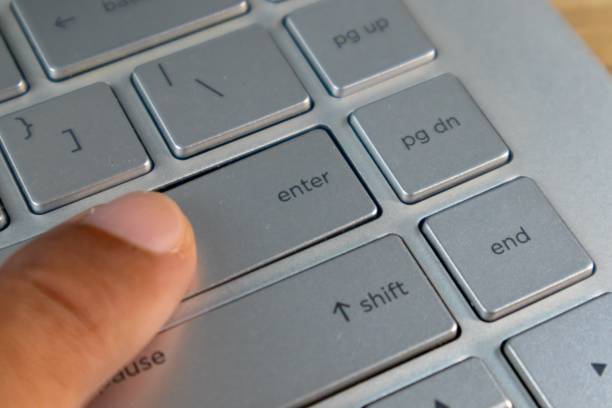 istock Index finger pressing the enter button on laptop keyboard 2199016261