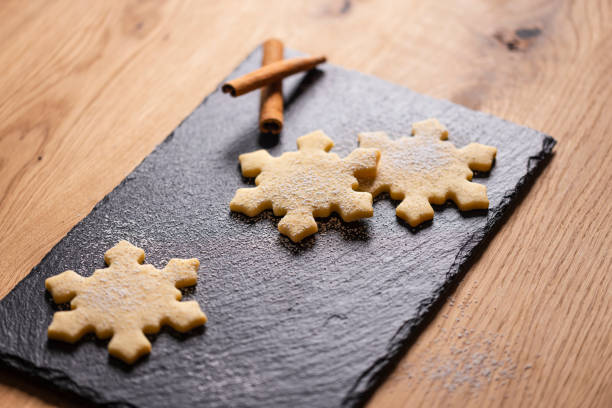 istock Delightful Christmas cookies shaped like snowflakes on a rustic slate tray 2199017487