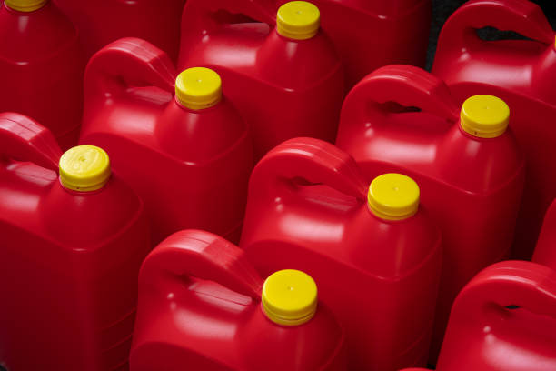 istock Top view texture of neat red plastic motor oil bottles, containers with handle and yellow screw cap 2199020983