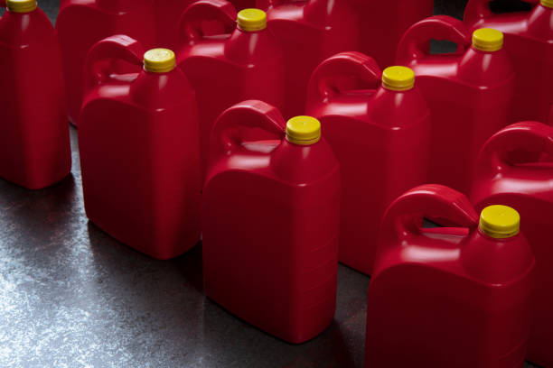 istock Top view of arranged red plastic motor oil bottles, containers with handle and yellow screw cap 2199020986