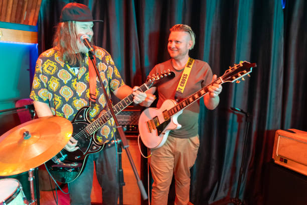 istock Middle aged rock musician having fun playing 2199021691