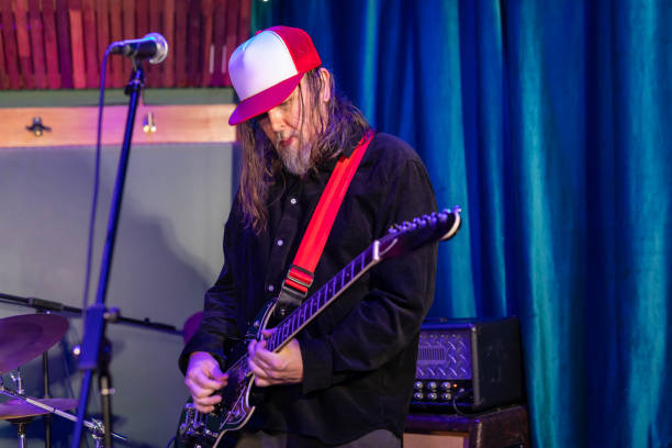 istock Middle aged rock musician having fun playing 2199021722