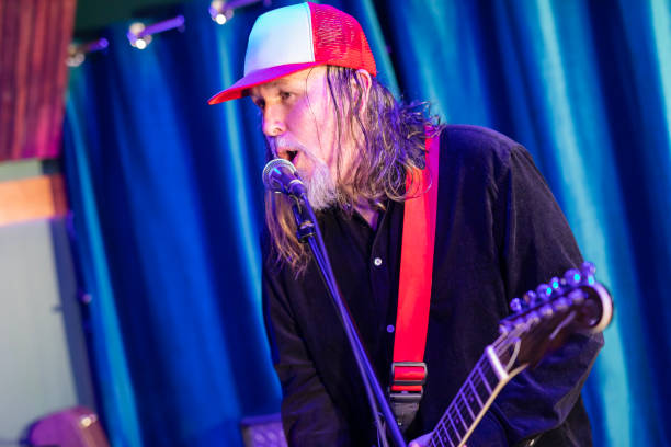 istock Middle aged rock musician having fun playing 2199021723