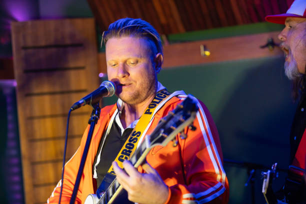 istock Middle aged rock musician having fun playing 2199021725