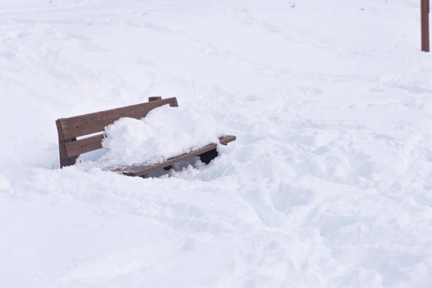 Wooden Bench Buried in Snow an avalanche buried the bank and the square