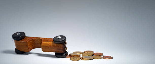 istock Wooden toy with coins symbolizing car expenses 2199025004