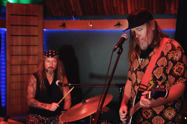 istock Two middle aged men playing music together 2199030897