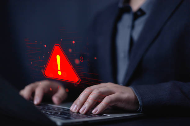 istock System hacked warning alert alarm on laptop. Notification virus of hackercrime, Spam virus with warning caution or Malicious software, Spyware, Malware or Malicious software. 2199031003