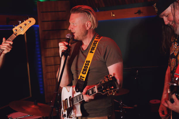istock Group of middle aged friends playing music together 2199031230