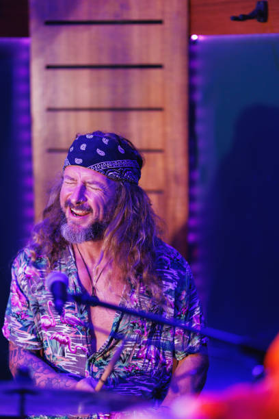 istock Drummer laughing and enjoying himself playing with his bandmates 2199031348