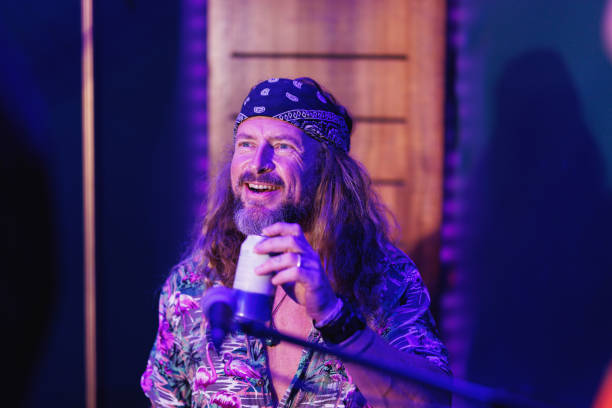 istock Drummer laughing and enjoying himself playing with his bandmates and having a beer 2199031909