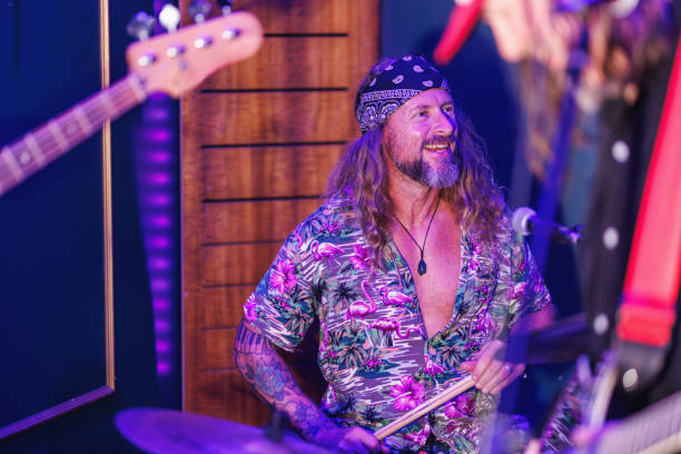 istock Drummer laughing and enjoying himself playing with his bandmates 2199031923