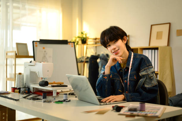 istock Cheerful young fashion designer working in a creative studio 2199031997