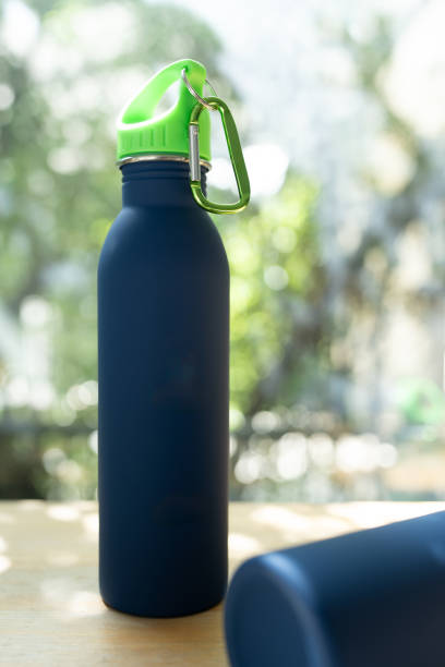 istock Full length blue water bottle against a nature background 2199032198