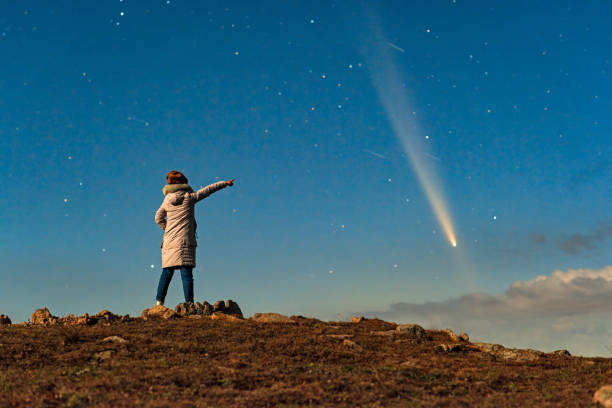 istock An Asian woman stood on a mountaintop watching a comet embrace a comet called Tsuchinshan ATLAS (C/2023 A3) against the backdrop of stars. 2199032786