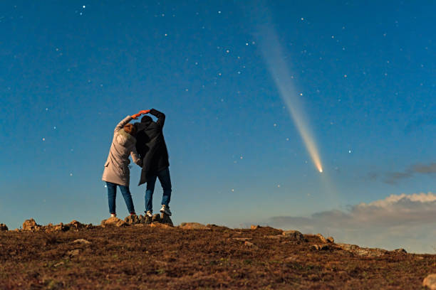 istock A couple stood on a mountaintop watching a comet embrace a comet called Tsuchinshan ATLAS (C/2023 A3) against the backdrop of stars. 2199032852