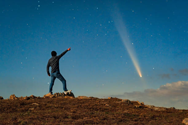 istock An Asian man stood on a mountaintop watching a comet embrace a comet called Tsuchinshan ATLAS (C/2023 A3) against the backdrop of stars. 2199032889