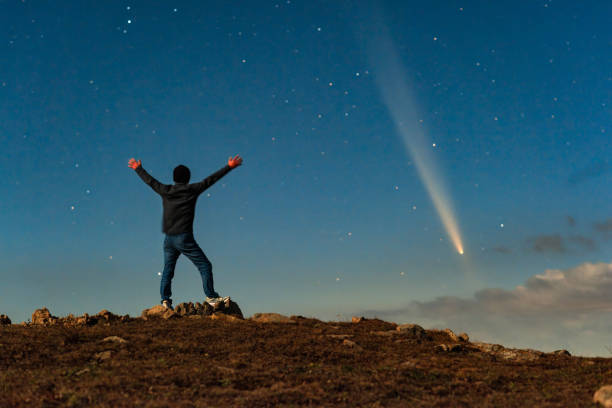 istock An Asian man stood on a mountaintop watching a comet embrace a comet called Tsuchinshan ATLAS (C/2023 A3) against the backdrop of stars. 2199032947