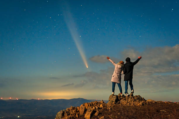istock A couple stood on a mountaintop watching a comet embrace a comet called Tsuchinshan ATLAS (C/2023 A3) against the backdrop of stars. 2199032954