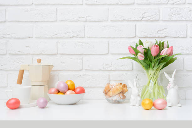 istock Easter regales and decorations on table with space in front of white brick wall background 2199033436