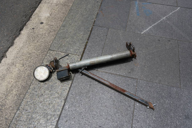 Old rusty metal surveying equipment abandoned on a footpath.