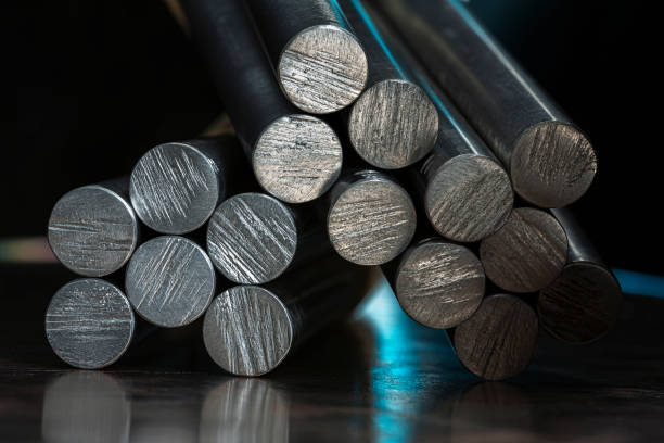 istock Stack of steel rods on a metal surface in an industrial space with cool blue lighting 2199035663
