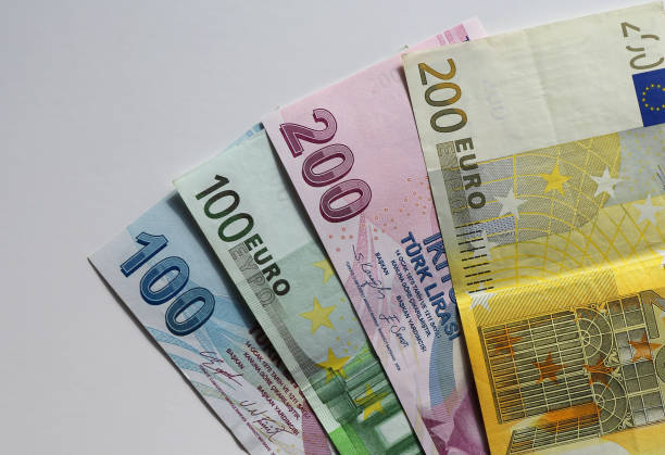 istock Euro and Turkish lira banknotes isolated on white 2199037106